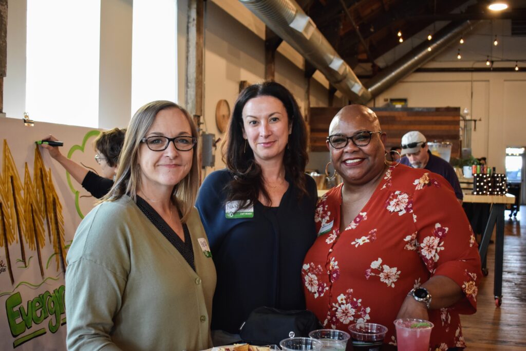 Three ETS staff members smile for a picture.