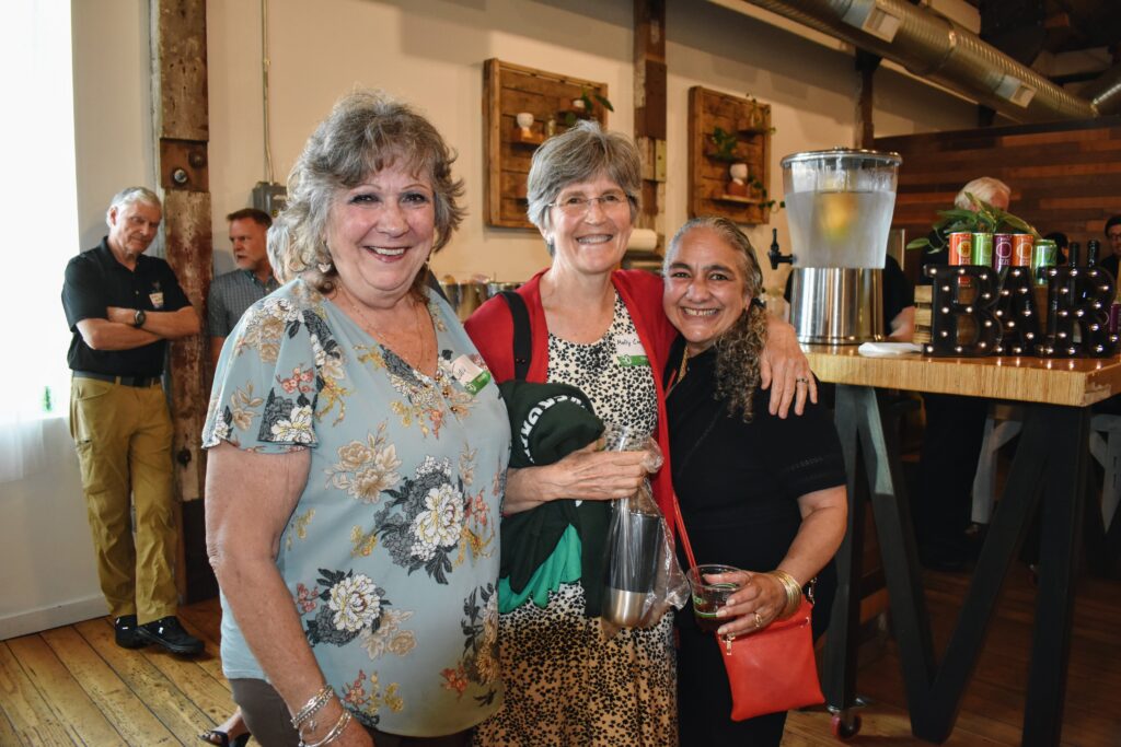 Three staff members smile for a picture.