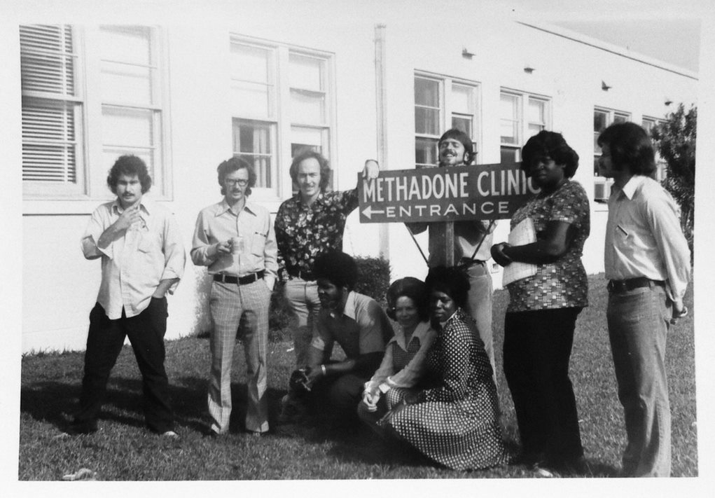 Ron Jackson, directly left of sign, at a methadone clinic in Corpus Christi, TX