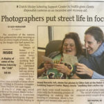 newspaper clipping with the headline "photographers put street life in focus" from 2000.