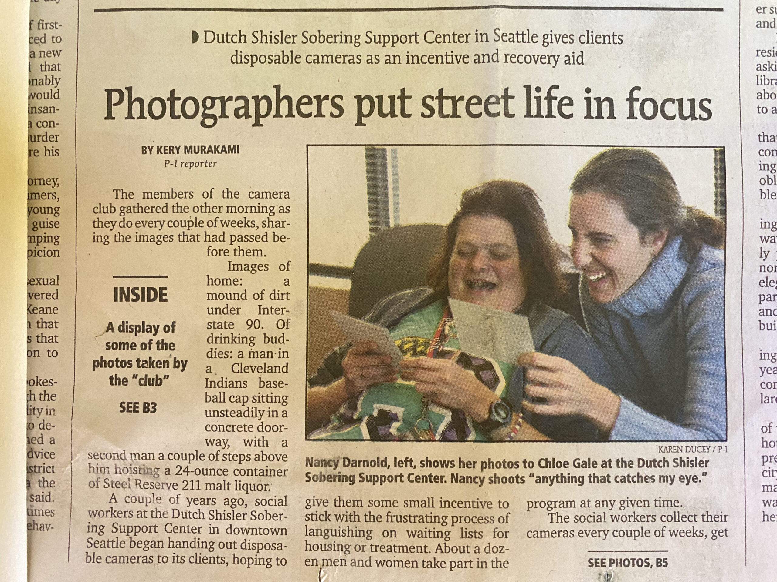 newspaper clipping with the headline "photographers put street life in focus" from 2000.